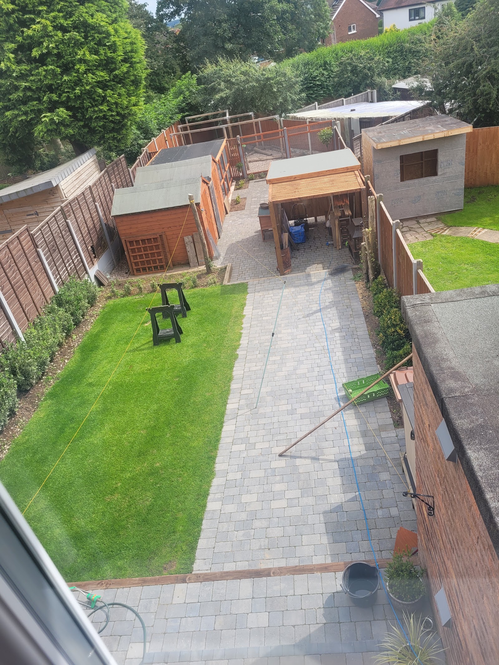 Long block-paved garden path running the length of a rear garden